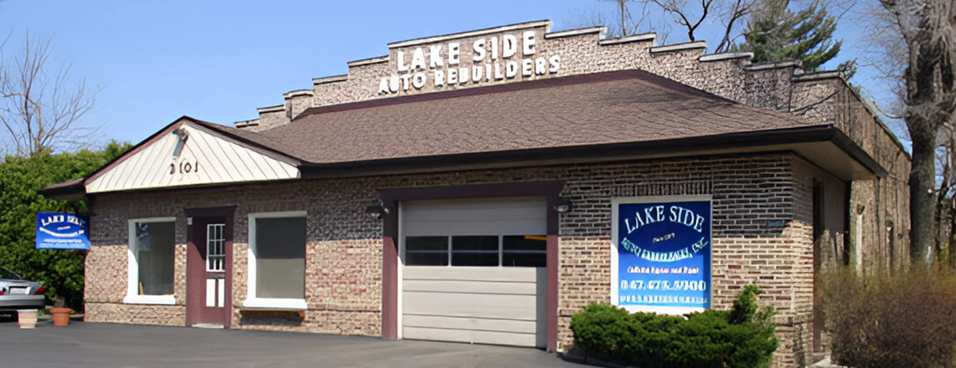 A building with a garage door and sign on it.